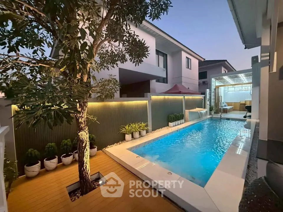Luxurious modern home with private pool and elegant outdoor lighting.