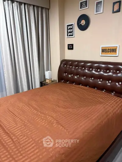 Luxurious bedroom with elegant decor and plush leather headboard, perfect for relaxation and comfort.