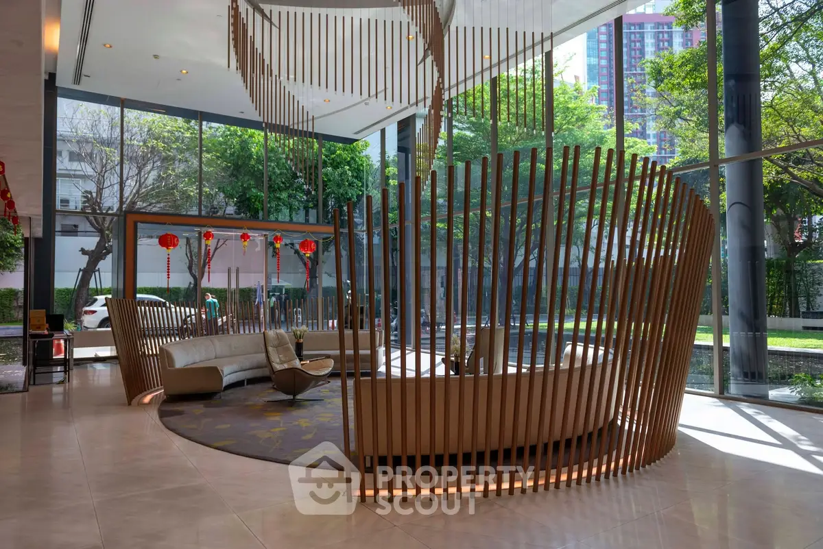 Luxurious modern lobby with unique wooden design and floor-to-ceiling windows offering lush garden views.