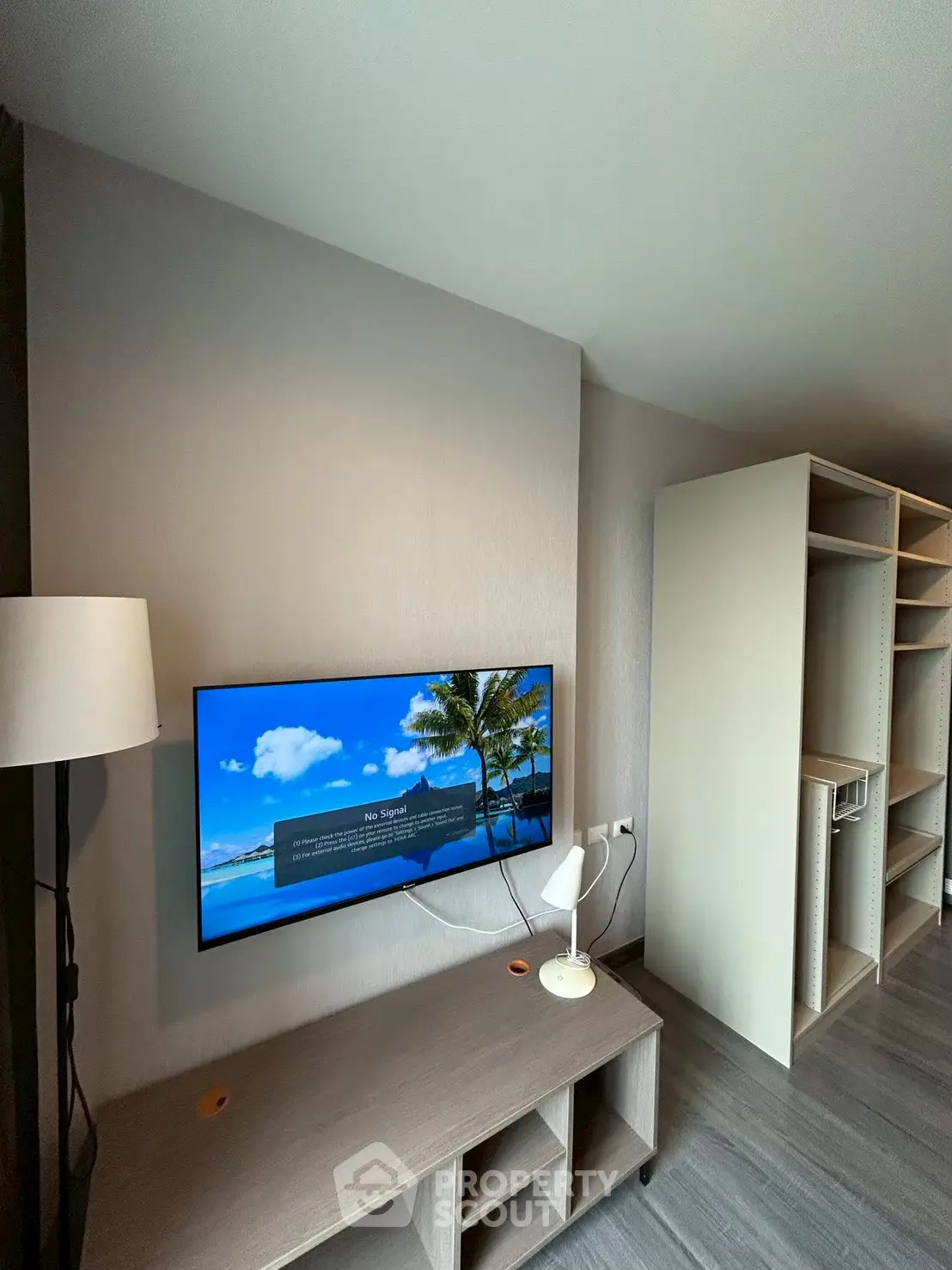 Modern living room with wall-mounted TV and sleek storage unit