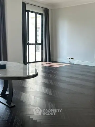 Spacious modern living room with elegant flooring and large window