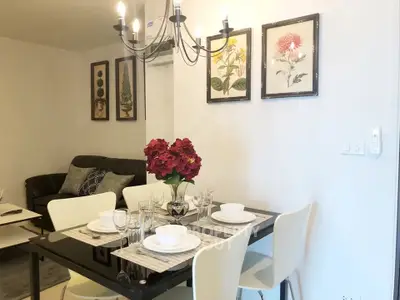 Elegant dining area with modern chandelier and stylish decor in a cozy living space.
