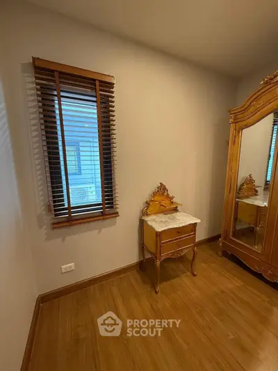 Elegant bedroom corner with vintage wooden furniture and large mirror