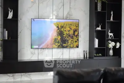 Luxurious living room with marble wall and modern TV display