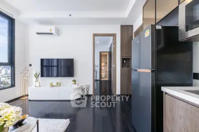Modern living room with sleek black flooring and stylish furniture in a high-rise apartment.