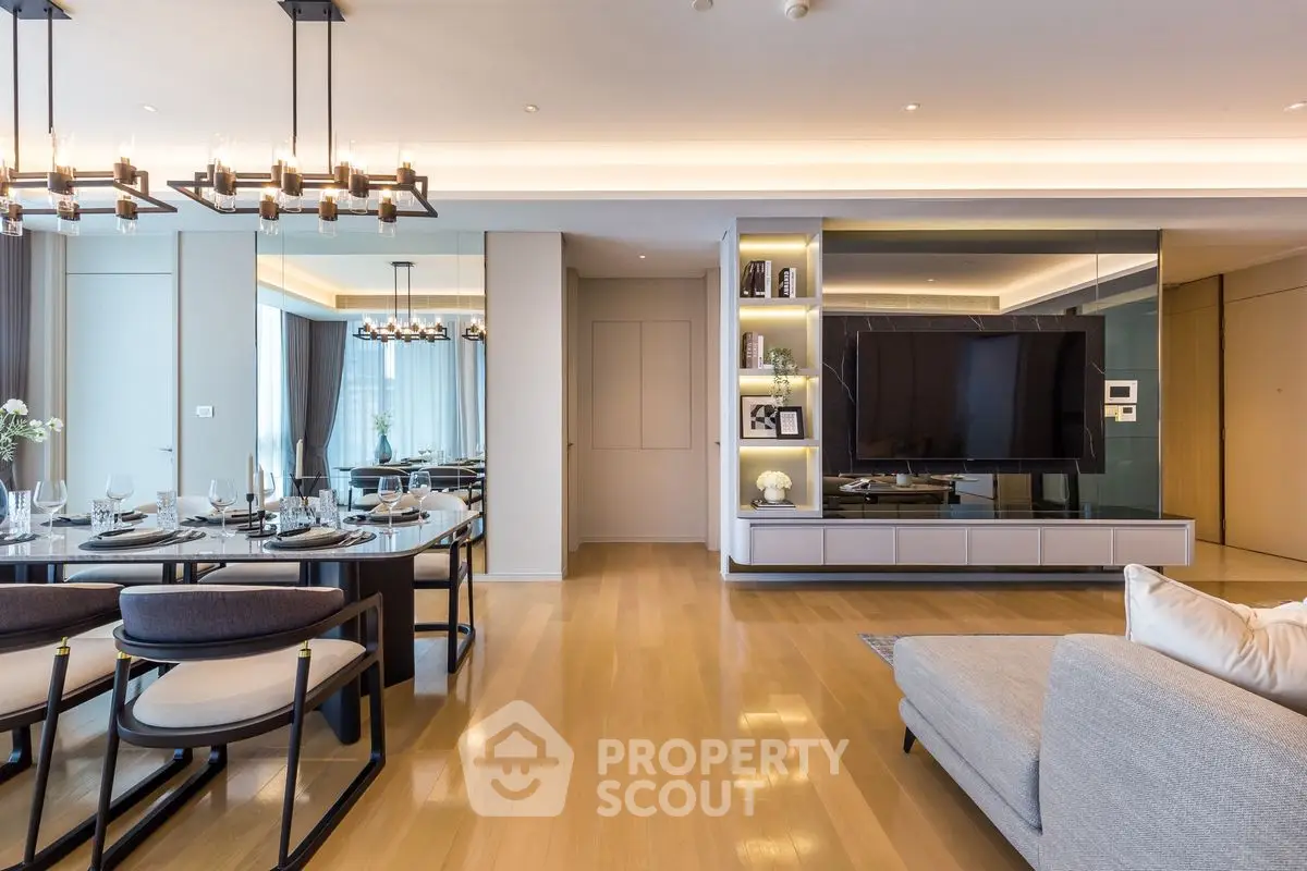 Luxurious modern living room with elegant dining area and large flat-screen TV, perfect for entertaining.