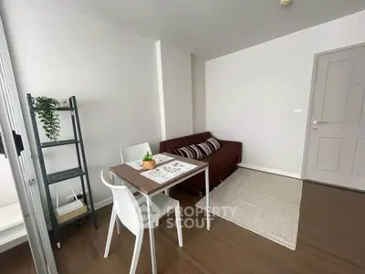 Cozy living room with modern decor and dining area in a stylish apartment.