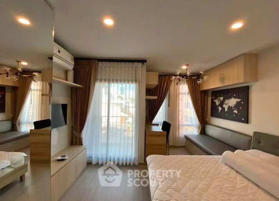 Modern bedroom with large windows, stylish decor, and ample natural light