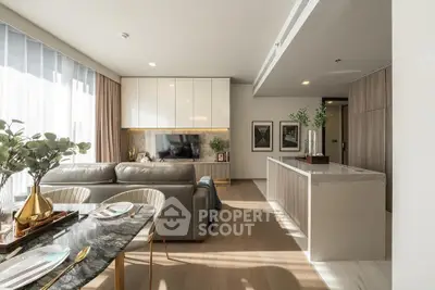 Modern open-plan living room with elegant decor and abundant natural light