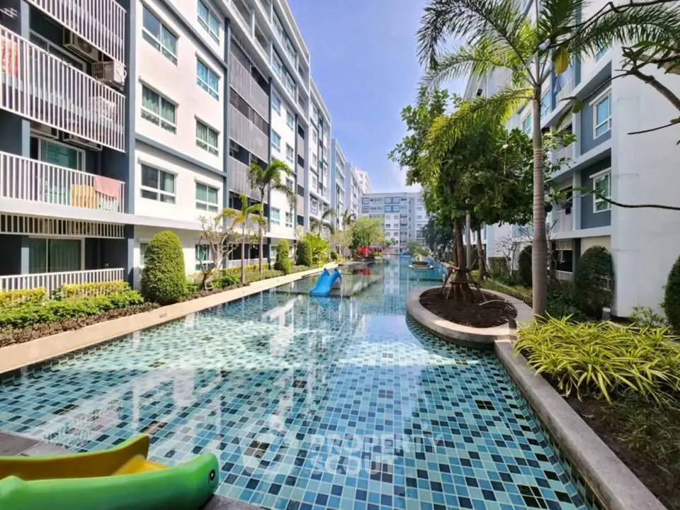 Stunning modern apartment complex with a serene pool and lush greenery