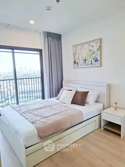 Bright and airy bedroom with city view, featuring modern decor and large windows for natural light.