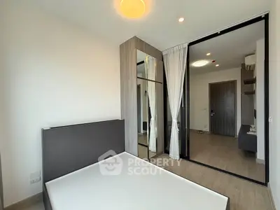 Modern bedroom with mirrored wardrobe and minimalist design