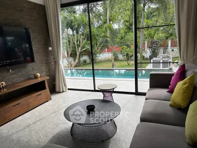 Luxurious living room with pool view, modern furniture, and large glass doors opening to a tropical garden.