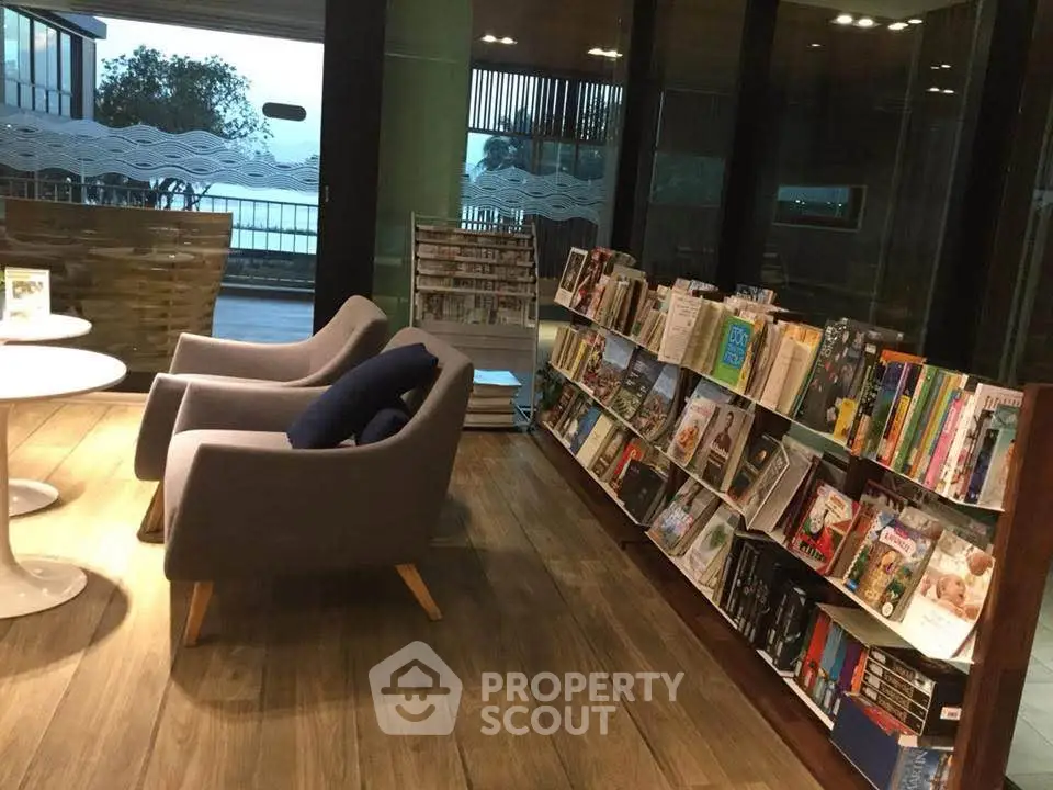 Chic library lounge with cozy seating and expansive book collection, perfect for relaxation and reading.