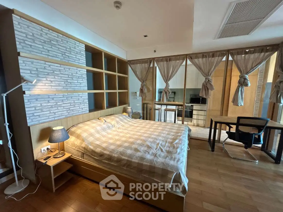Spacious bedroom with modern decor and open layout in luxury apartment.