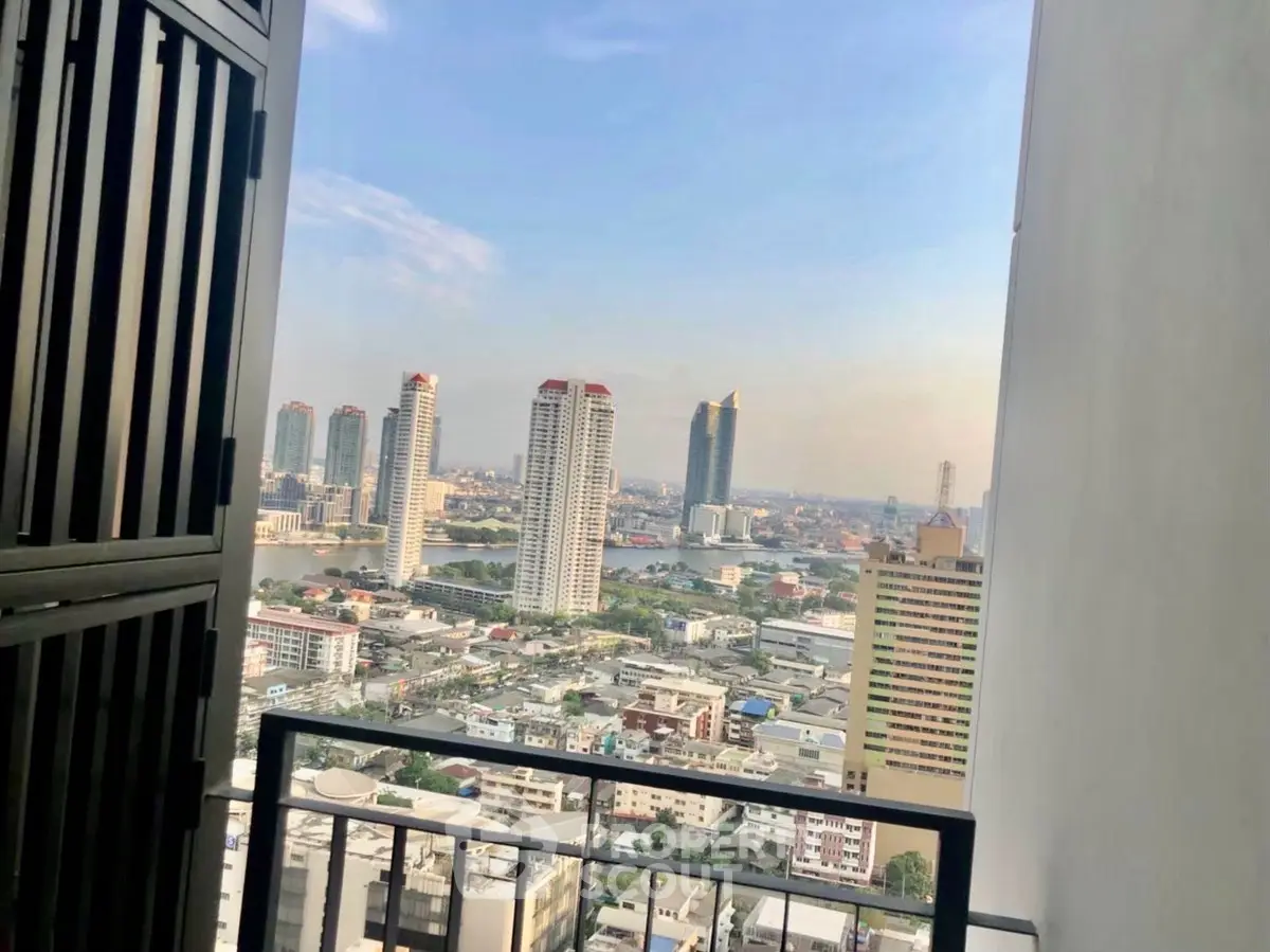 Stunning cityscape view from a high-rise balcony overlooking urban skyline.