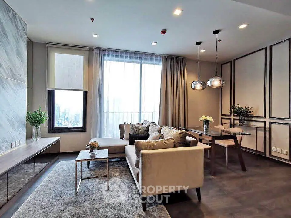 Luxurious modern living room with elegant decor and city view, featuring plush seating and stylish lighting.