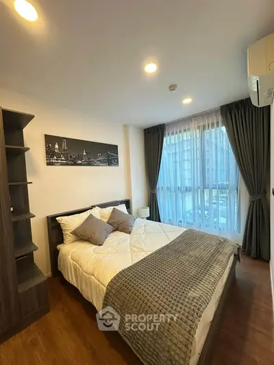 Cozy bedroom with modern decor and large window for natural light