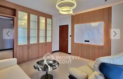 Modern living room with elegant lighting and marble accent wall