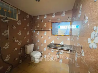 Charming bathroom with floral tile design and modern fixtures