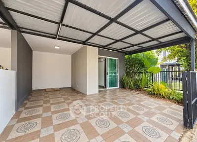Spacious covered patio with tiled flooring and garden view, perfect for outdoor relaxation.