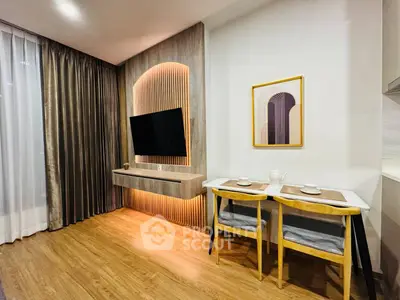 Modern living room with stylish decor and dining area, featuring a wall-mounted TV and elegant lighting.