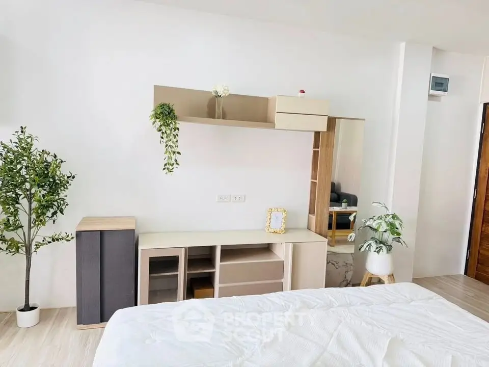 Modern bedroom with stylish decor and ample storage space