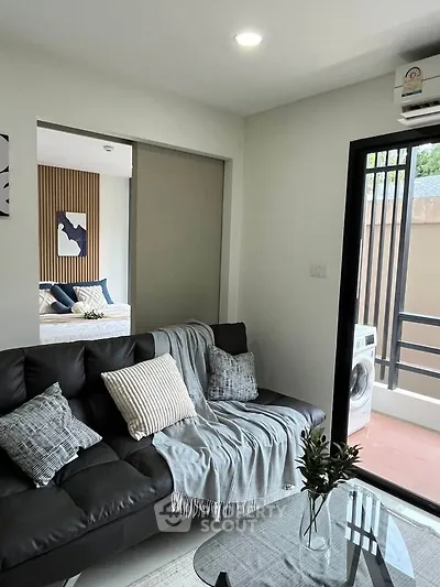 Modern living room with cozy sofa and balcony view