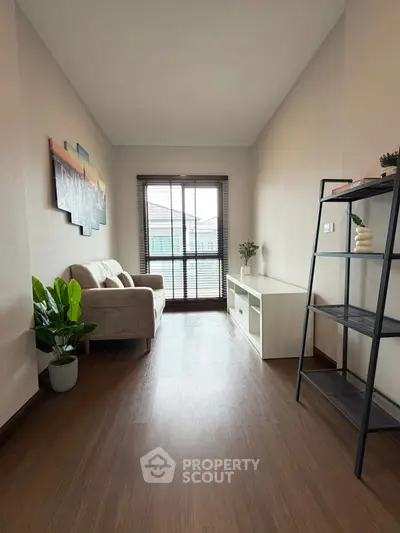 Cozy and bright living room with modern decor and large window view.