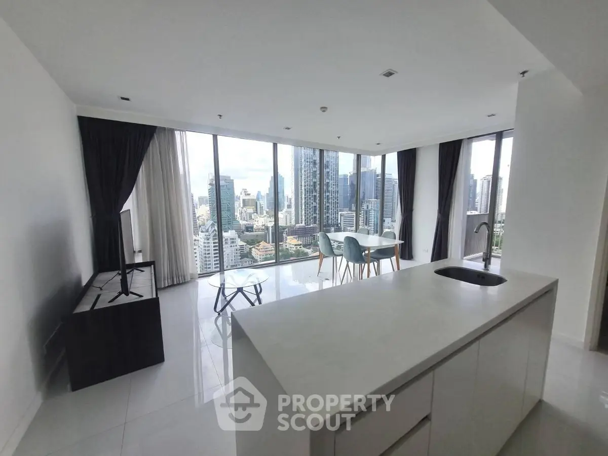 Spacious modern living room with stunning city view and open kitchen layout.