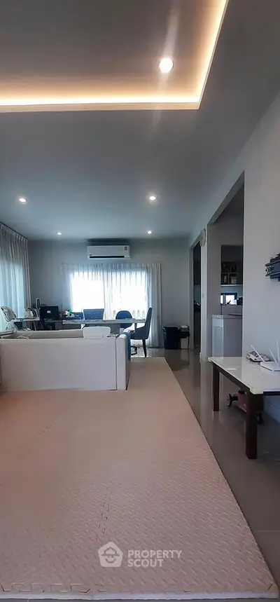 Spacious modern living room with elegant lighting and large windows