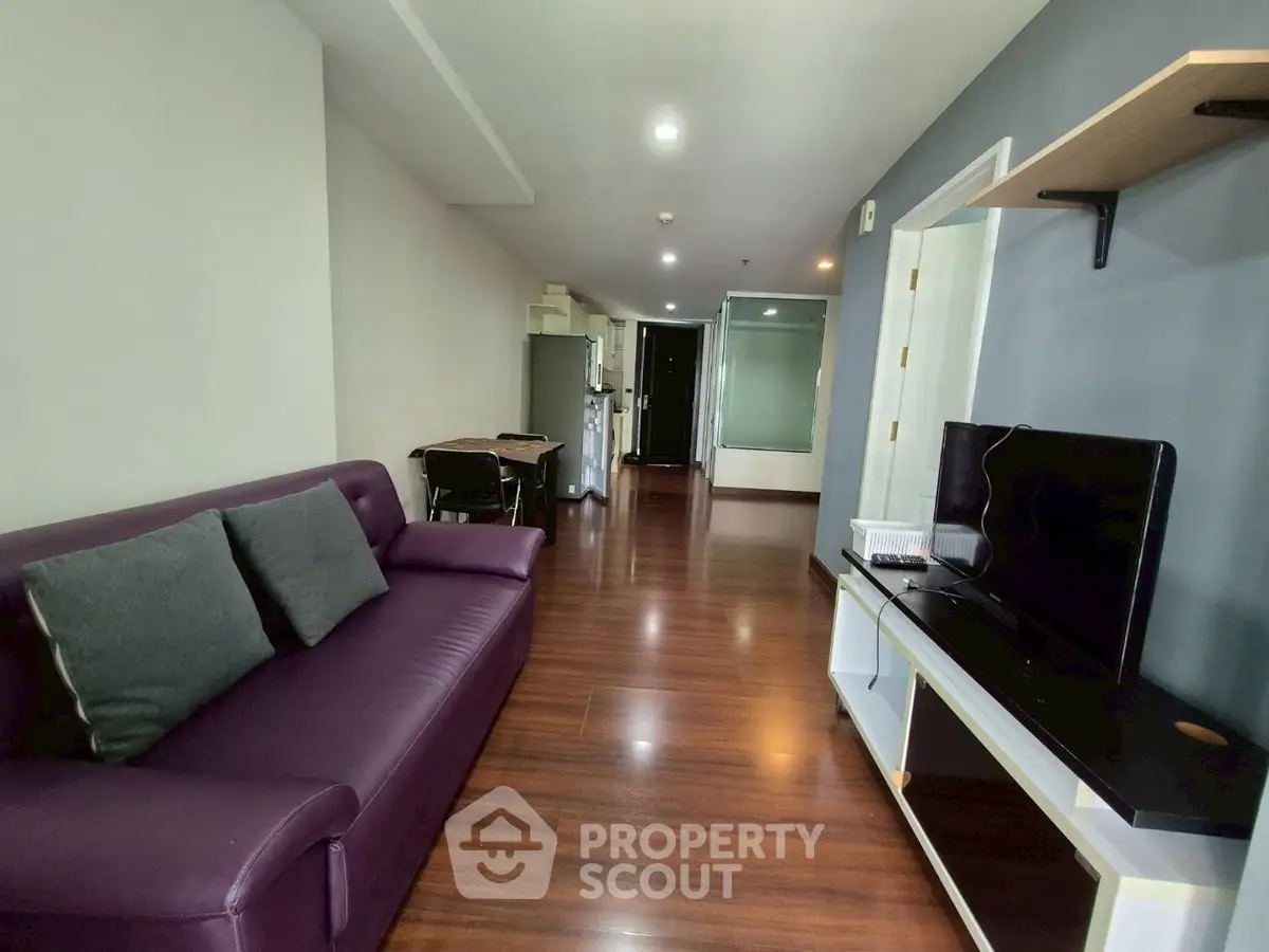 Modern living room with sleek furniture and hardwood floors in a stylish apartment.