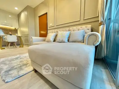 Elegant living room with plush sofa and modern decor in a stylish apartment.