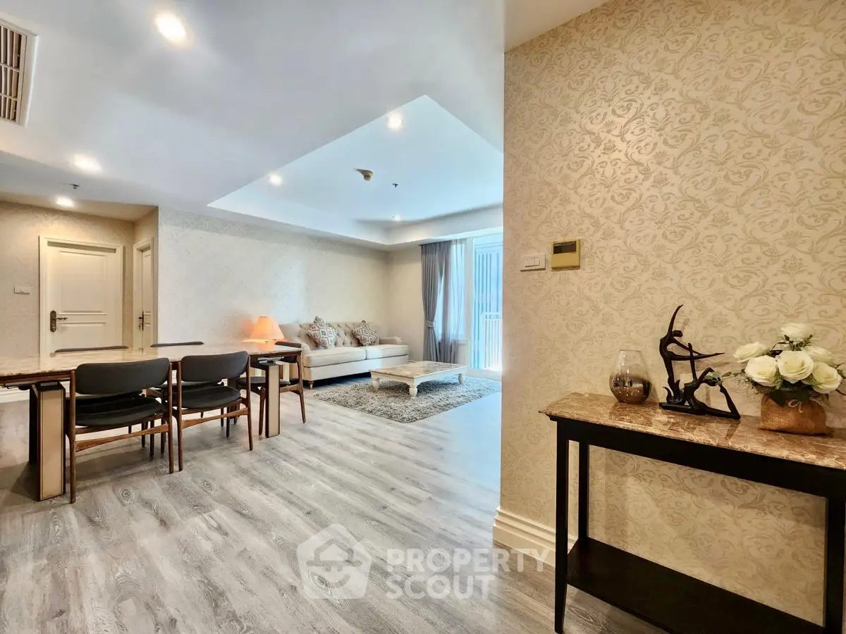 Spacious living room with elegant decor and natural light, featuring modern furniture and stylish flooring.