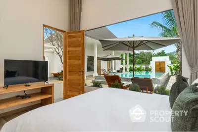 Luxurious bedroom with pool view, open doors to patio, modern decor, and natural light.