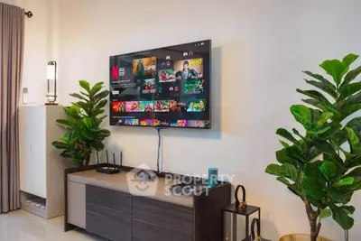 Modern living room with wall-mounted TV and stylish decor