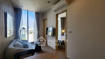 Modern living room with city view, featuring sleek furniture and air conditioning, perfect for urban living.
