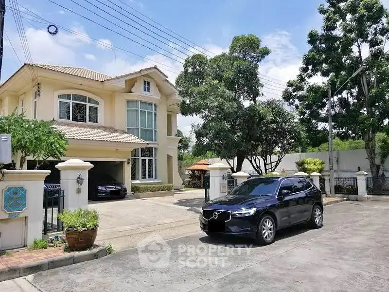 Elegant suburban house with spacious driveway and lush greenery, perfect for family living.