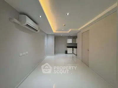 Modern minimalist interior with sleek lighting and air conditioning in a compact living space.