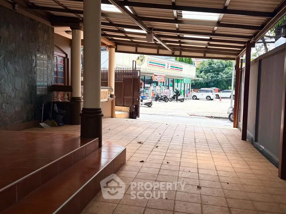 Spacious covered parking area with tiled flooring and street view
