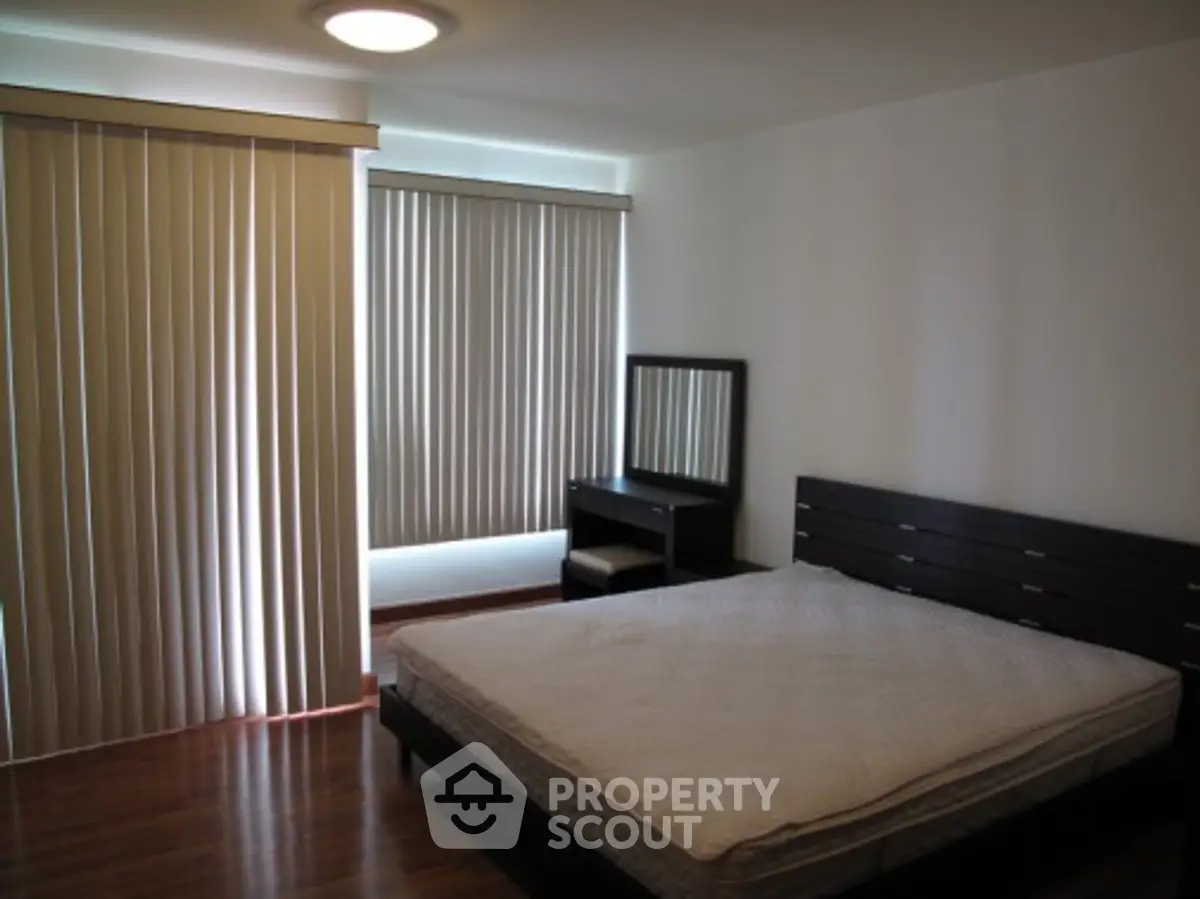 Spacious bedroom with modern furniture and natural light