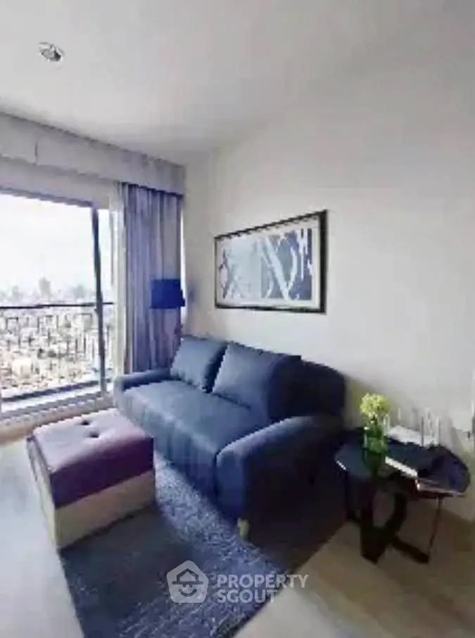 Modern living room with stylish sofa and large window offering city view