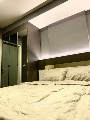 Modern bedroom with sleek design and ambient lighting, featuring a comfortable bed and mirrored wardrobe.