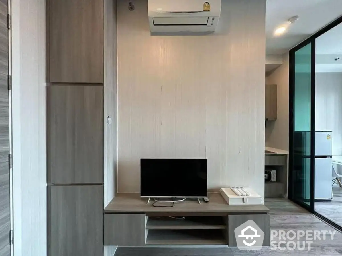 Modern living room with sleek TV stand and air conditioning unit