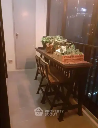 Charming balcony with cozy seating and lush plants, perfect for relaxing evenings.