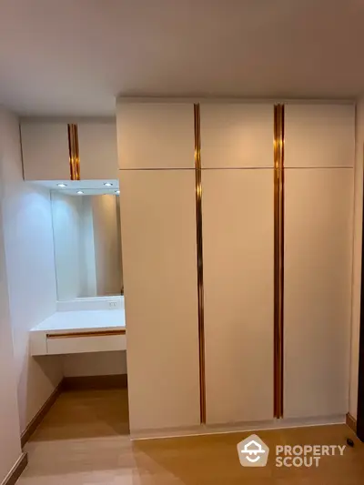 Modern bedroom with elegant built-in wardrobe and vanity area