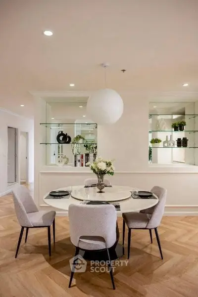 Elegant dining area with modern decor and stylish lighting in a luxurious apartment.