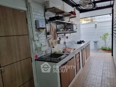 Charming outdoor kitchen with modern appliances and ample counter space, perfect for culinary enthusiasts.