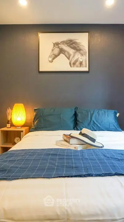 Cozy bedroom with stylish decor and warm lighting, perfect for relaxation.