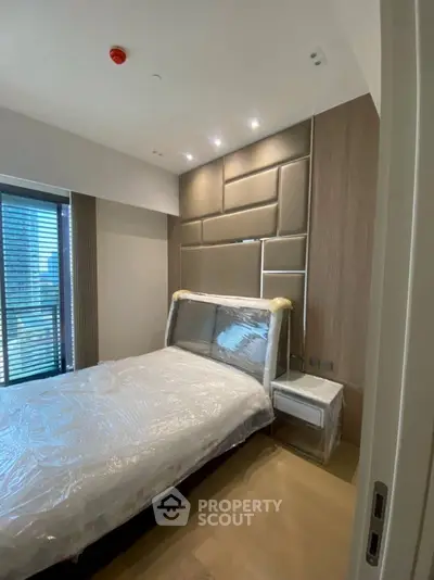 Modern bedroom with stylish headboard and natural light